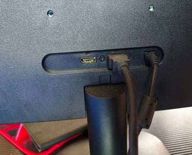 Detalhe das portas de conectividade traseiras do monitor AOC Q27B35E com cabos HDMI e de alimentação
