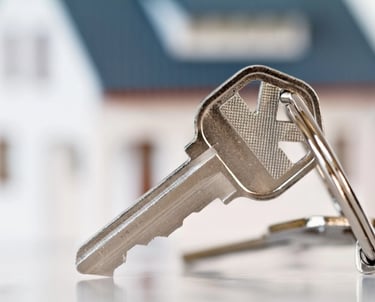 picture of a key in front of a blured house
