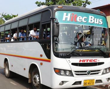 A vibrant bus traveling through scenic South Indian landscapes with temples in the background