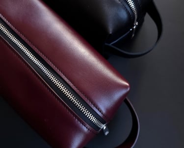 Burgundy and black leather toiletry bags 