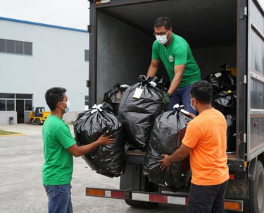 Friendly crew members loading furniture and boxes into a cargo truck.