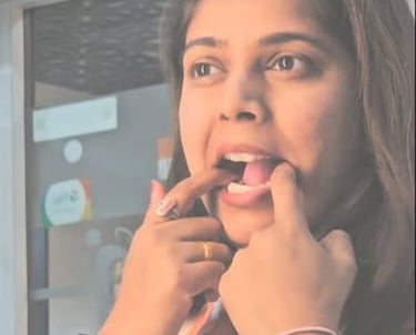 A woman demonstrating clear teeth aligners on her teeth