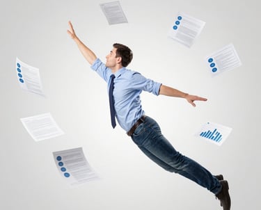 A modern workspace with a laptop displaying app designs, surrounded by sketches and coffee.