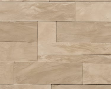 Close-up of a decorative stamped concrete patio with intricate stone patterns in soft gray tones.