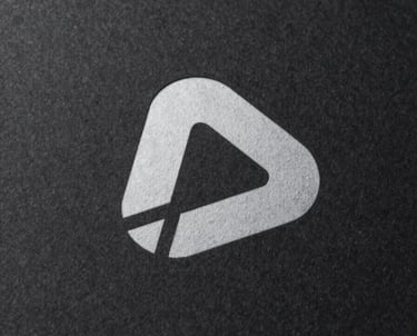 Modern minimalist logo of a software company presented on a textured dark paper, premium lighting.