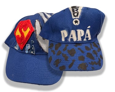 Baseball caps hand decorated by J.N.'s children.