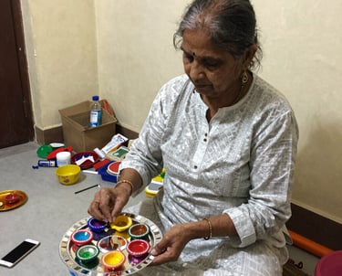 A close-up of a smiling artisan woman weaving vibrant fabric by hand in a sunlit workshop.