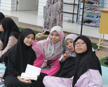 a group of women sitting on a blanket