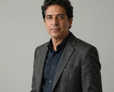Portrait of a creative director in a minimalist studio in Latin America. They wear professional attire and look confidently at the camera. Soft, high-quality studio lighting.