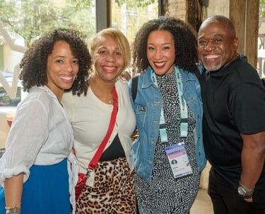 A group of four smiling diverse professionals networking during SXSW EDU 2026
