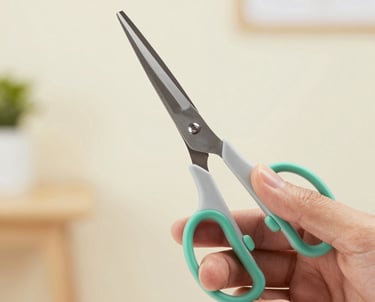 A close-up photograph of a hand testing the grip of modern ergonomic scissors, North American / US design studio background, bright and airy lighting, focusing on comfort and precision, using light gray and medium green accents.