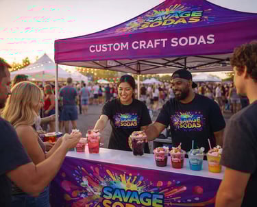 Savage Sodas pop-up booth serving custom dirty sodas at a public event with staff and festival crowd