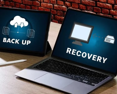 A laptop and tablet displaying data backup and recovery icons for cloud storage services.