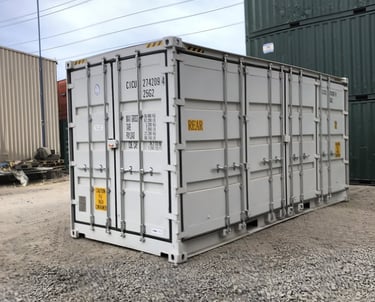 White steel side-opening shipping container with multiple doors for easy loading access in a gravel yard.