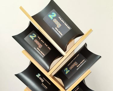 2 Easy’ back‑pain relief products arranged on a wooden display