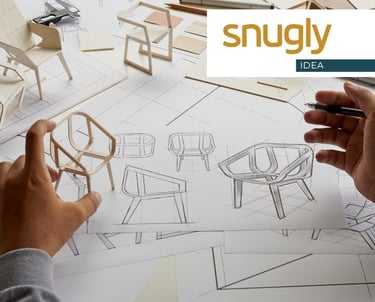 Designer sketching modern chair blueprints with wooden miniature furniture models for product development.