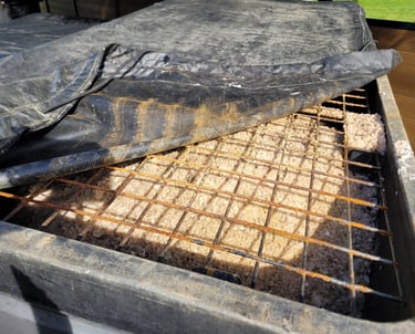 a top picture of a salt hopper filled with salt with a metal grate