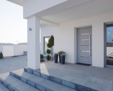 a house with a large front door and steps leading to the front door