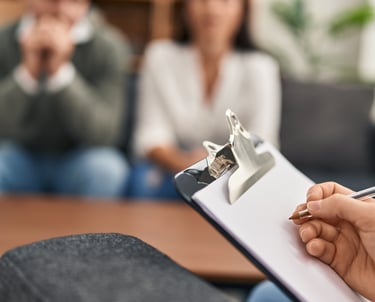 a woman is holding a clipboard and a pen