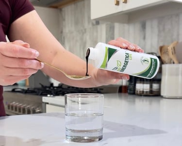 Bioenergetica Life liquid supplement being poured into a spoon, designed for easy daily absorption