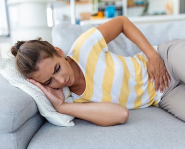 Mujer jovén recostado por dolor menstrual