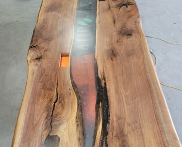 Custom black walnut epoxy river boardroom table — production top view