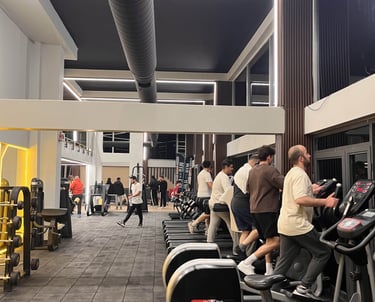 a gym room with a lot of people on the floor