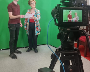 Participants learning on-camera performance techniques in a green screen filmmaking workshop