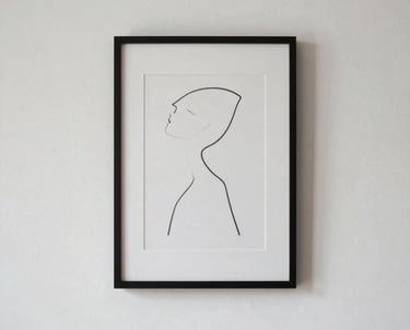 A minimalist wall with a single framed minimalist artwork of a line drawing. Reflects the aesthetic of simplicity and focus.