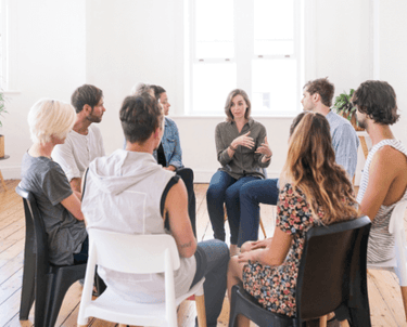 a group of people sitting around a table