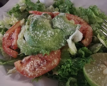 Ensalada fresca con aguacate, jitomate y queso parmesano rallado, la guarnición artesanal ideal para acompañar tus platillos.