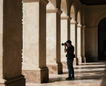A photographer capturing an architectural detail in a sunlit space. South American &amp;#x2F; Brazilian setting, cinematic feel.