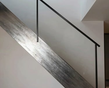 A technical rendering of a modern staircase in a residential home, focusing on the interplay of steel and light, highlighting the precision of architectural modeling.