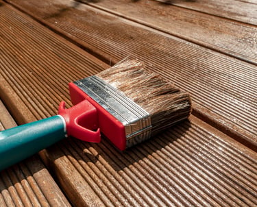 Paint brush on wooden deck for exterior painting