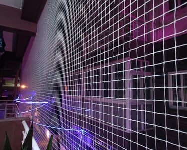 Close-up of a freshly installed balcony safety net on a high-rise apartment in Thane West.