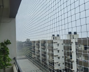 Close-up of strong, fine mesh safety netting stretched tightly over a balcony.
