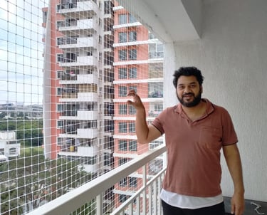 Close-up of a sturdy balcony safety net securely installed on a high-rise apartment in Mumbai.