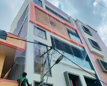 Technician carefully measuring a balcony for custom safety net fitting in a high-rise building.