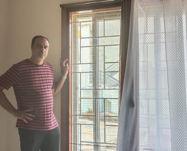Close-up of a balcony with neatly installed velcro mosquito net in bright daylight.