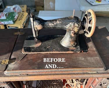 Vintage black cast iron sewing machine with rust on a wooden cabinet ready for restoration.