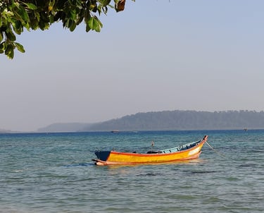 Andaman trip details - A colorful traditional boat anchored in the crystal-clear azure waters of Hav