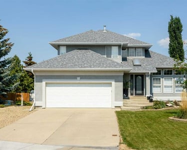 painted stucco house exterior. bright grey professionally painted exterior in red deer