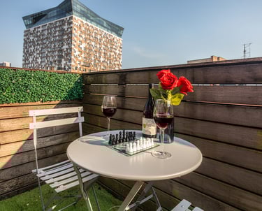 Private balcony at Birmingham B1 apartment with outdoor table, chairs and city view