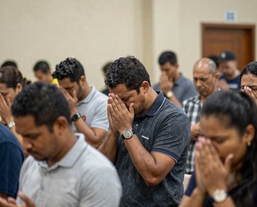Congregation worshiping together in a warmly lit church interior during a Sunday service.