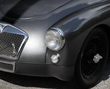 Close up view of the front of a silver 1958 MG MGA Roadster,