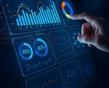Hand pointing at digital analytics dashboard showing campaign performance charts and metrics