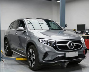 A skilled mechanic carefully inspecting a car engine under bright garage lights.