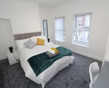 bedroom with bed and white walls