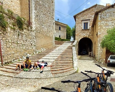 bicycles parked in front of a stone building