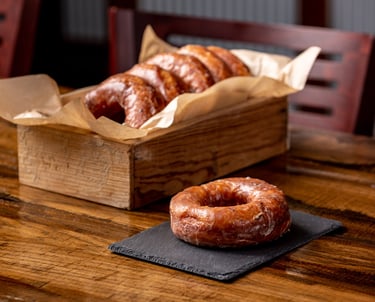 Glazed donuts in a rustic wooden box